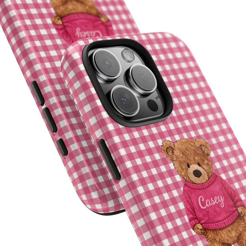 Pink gingham phone case corner with teddy patch and burgundy sweater; raised camera cutout