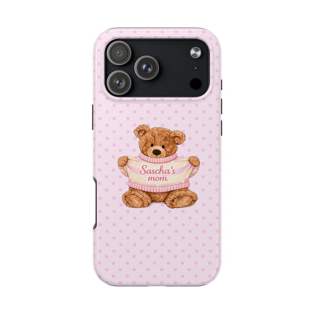 Pink polka-dot phone case with teddy bear face in pink sweater, 'Sascha's mom' text.