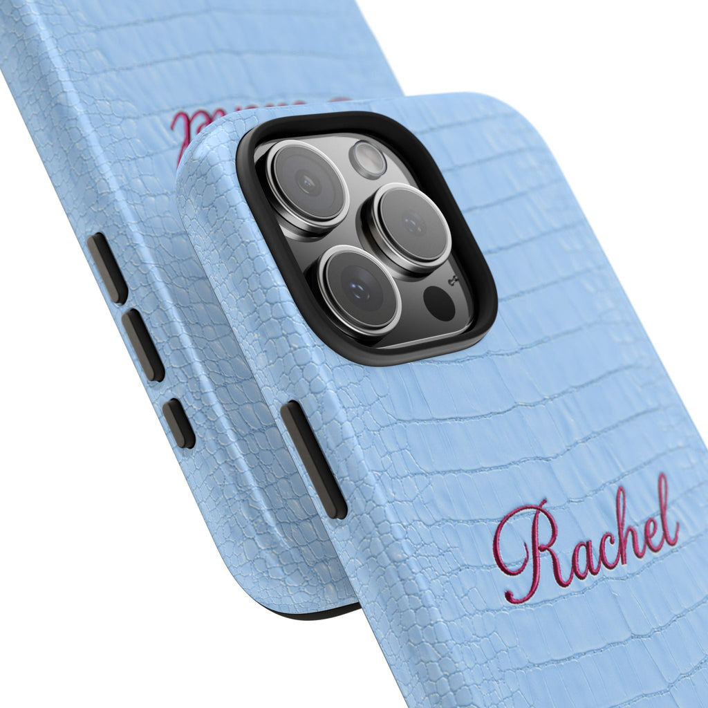 Angled light blue croc phone case with red “Rachel” name and camera cutout