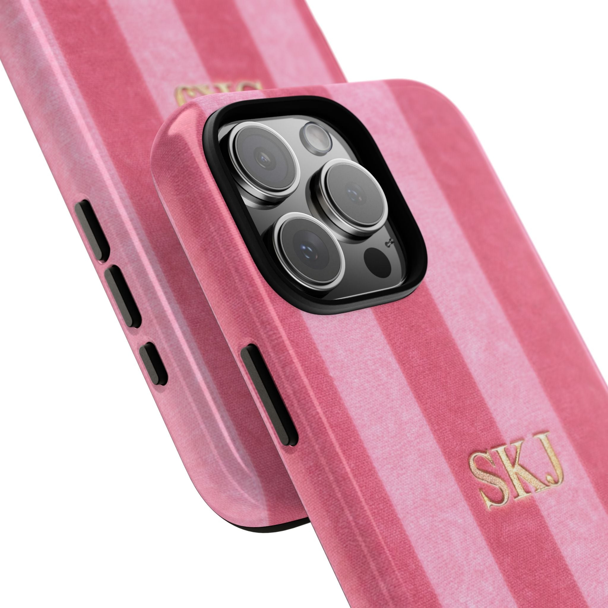 Pink velvet striped phone case close-up: gold “SKJ” initials and camera lenses.