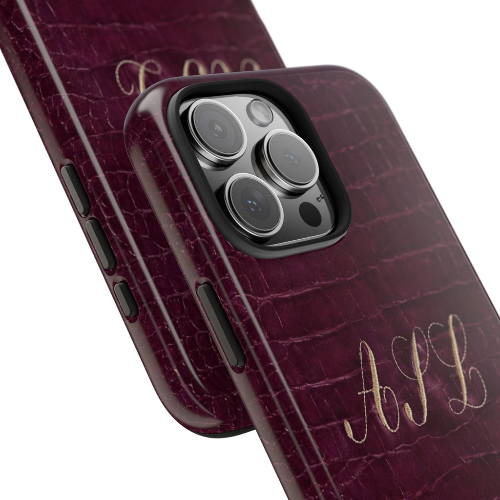 Side view plum croc phone case with custom initials and raised camera lens area