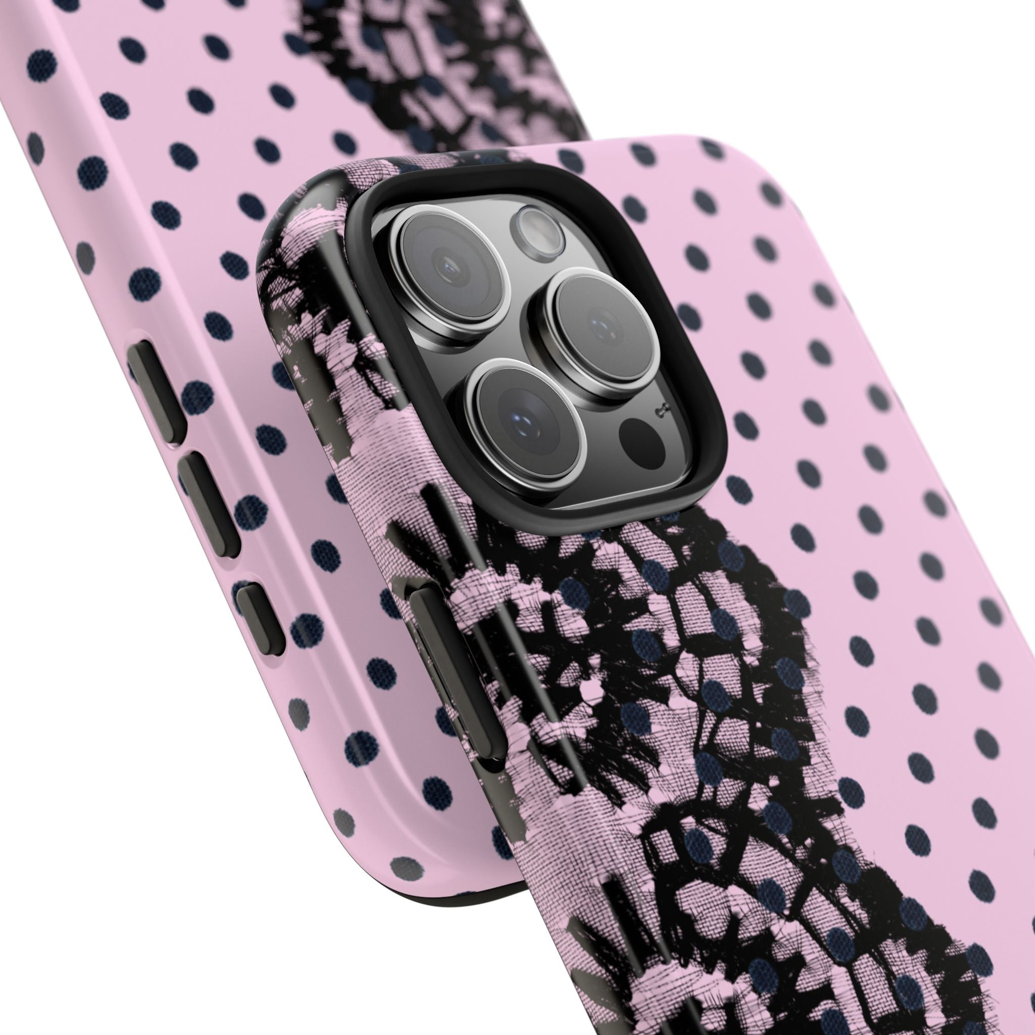 Close-up: pink phone case with black lace floral and polka dots around camera lenses