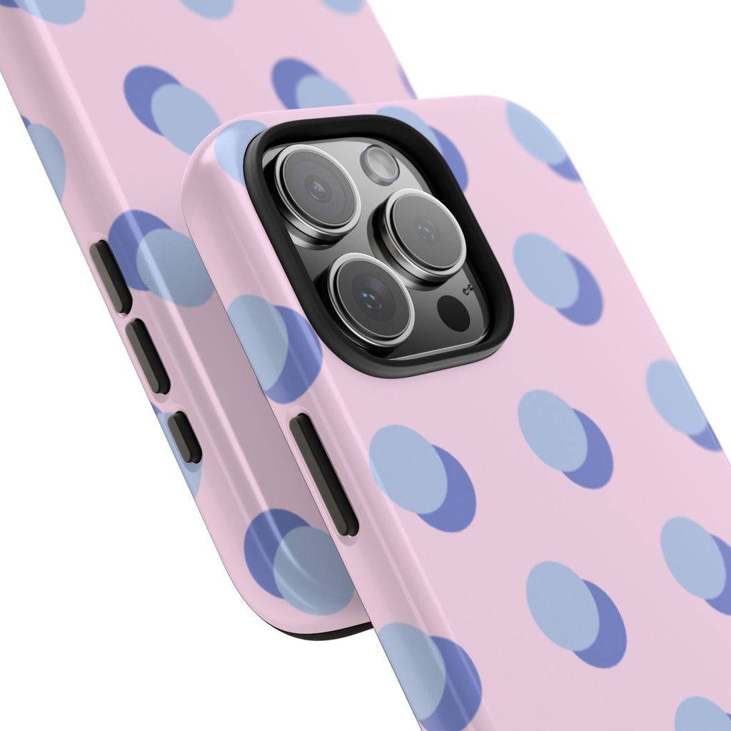 Pink phone case with blue polka dots, angled view showing side button cutouts