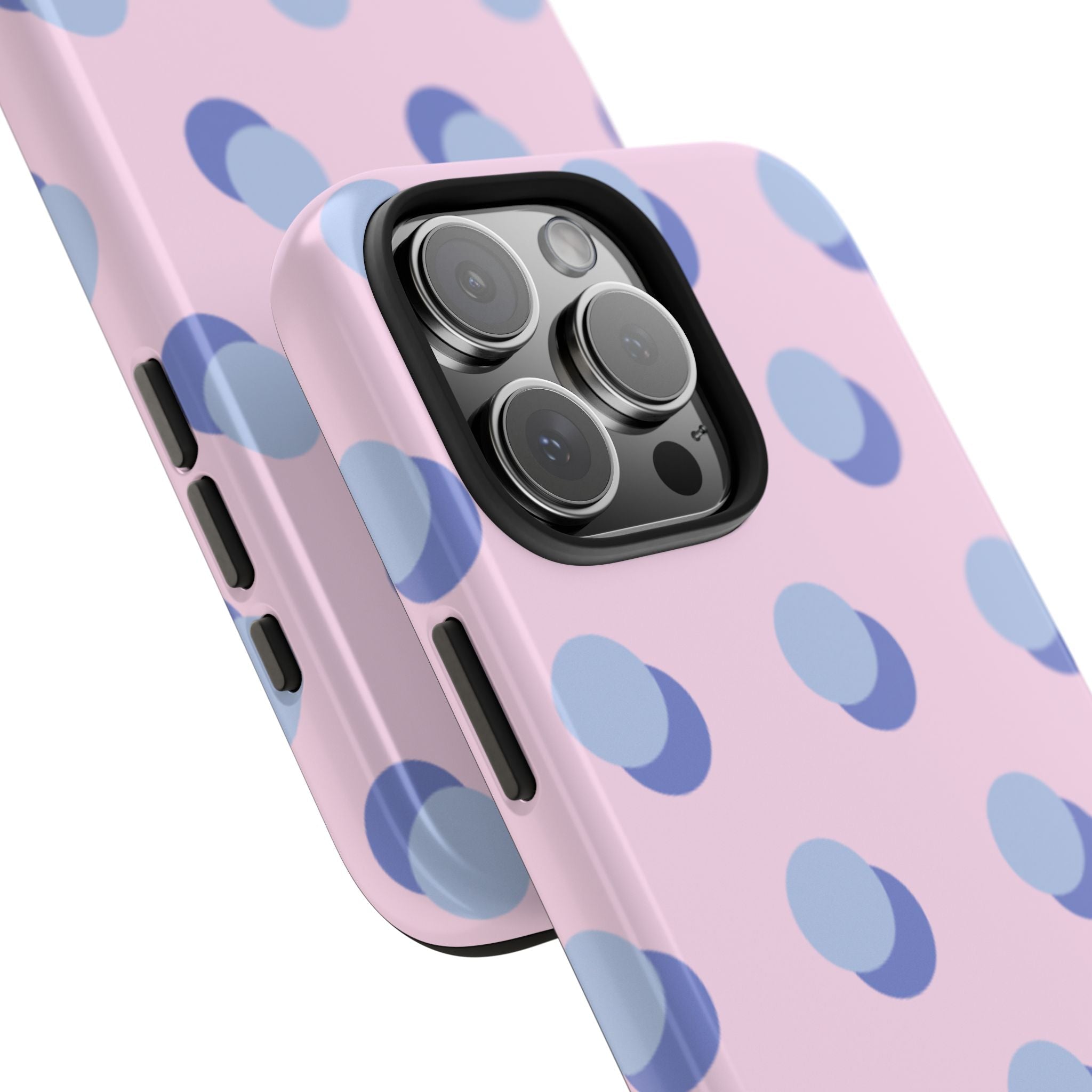 Pink phone case with blue polka dots, angled view showing side button cutouts