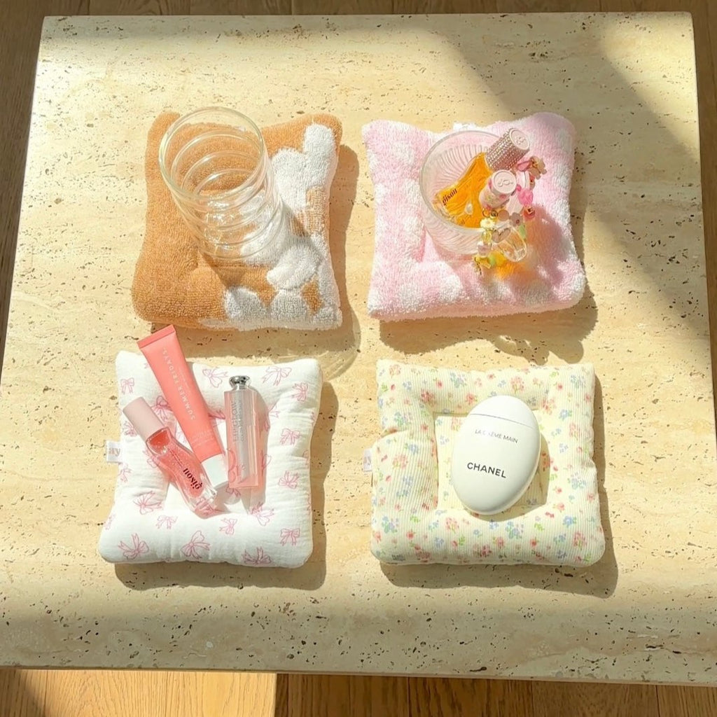 Set of four cloud-pattern coasters: yellow, pink, white floral, and light multicolor
