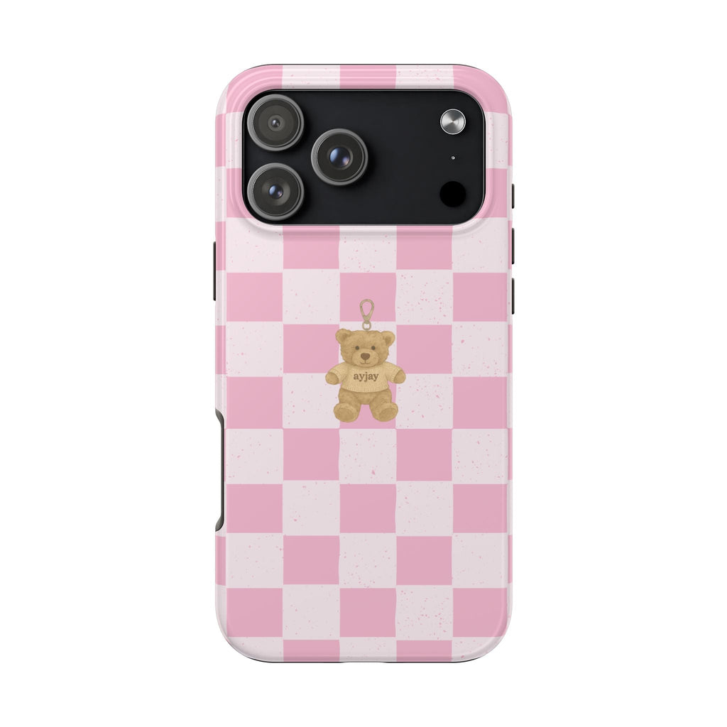 Pink checkered phone case with teddy bear keychain charm; camera and flash cutouts