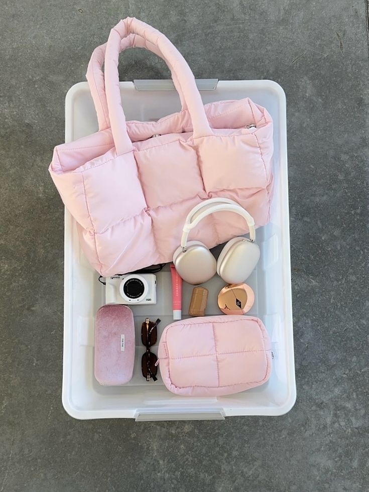 Pink puffer duffle tote bag lying open, padded interior with two top handles
