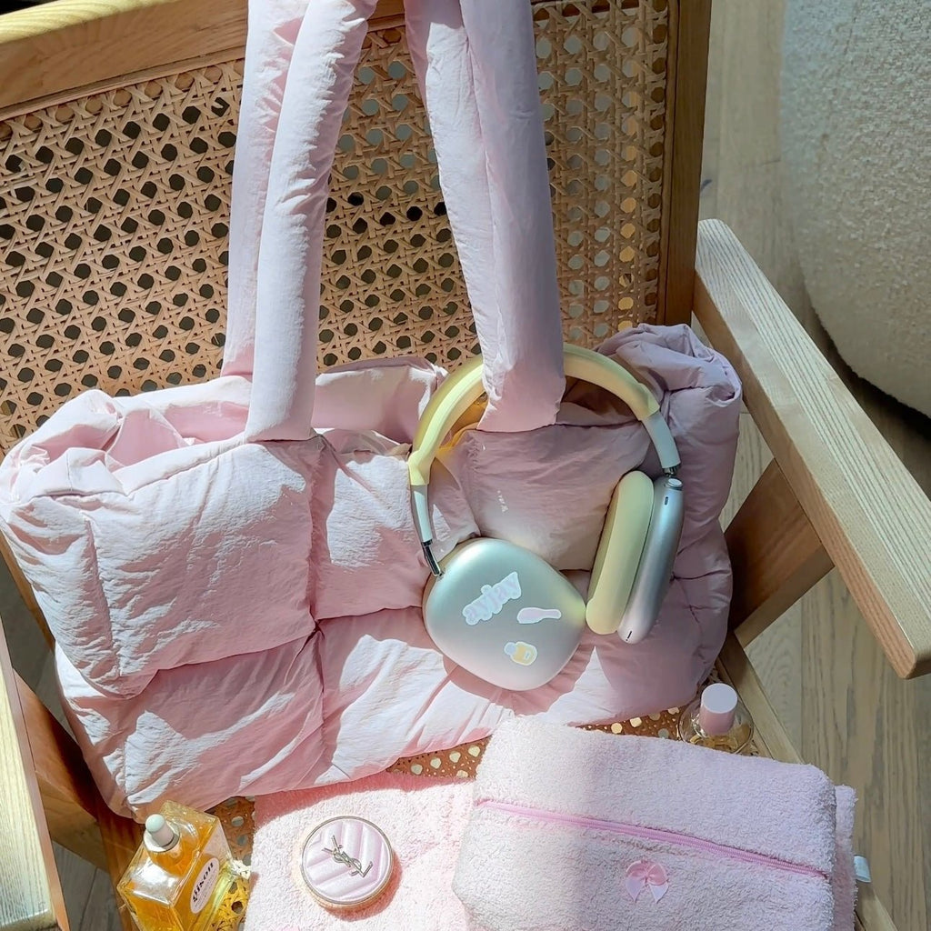 Pink quilted puffer duffle tote bag with upright handles, open-top style