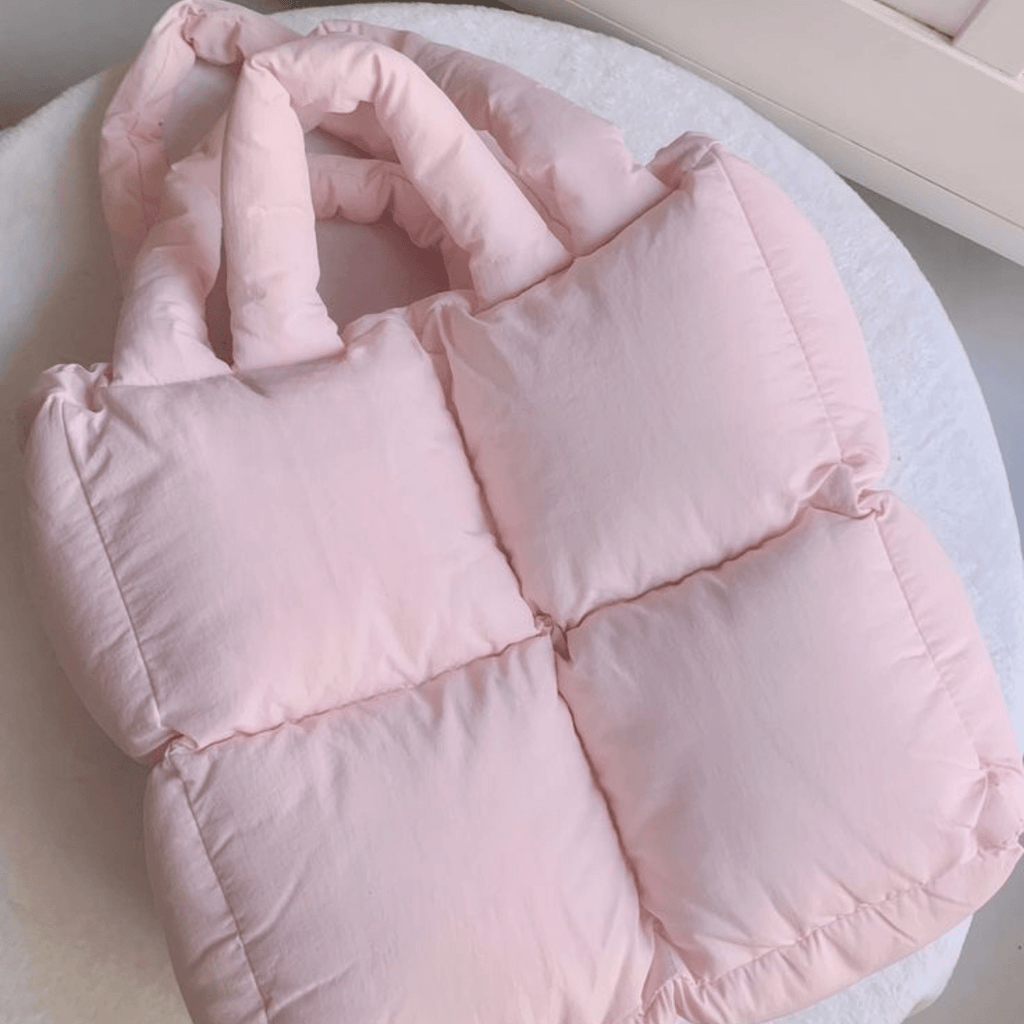 Light pink quilted puffer tote bag, padded panels with visible stitched seams