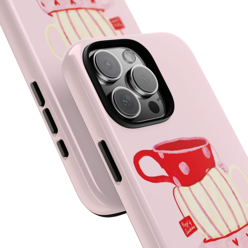 Angled close-up of pink phone case with red tea cup and striped cup graphic