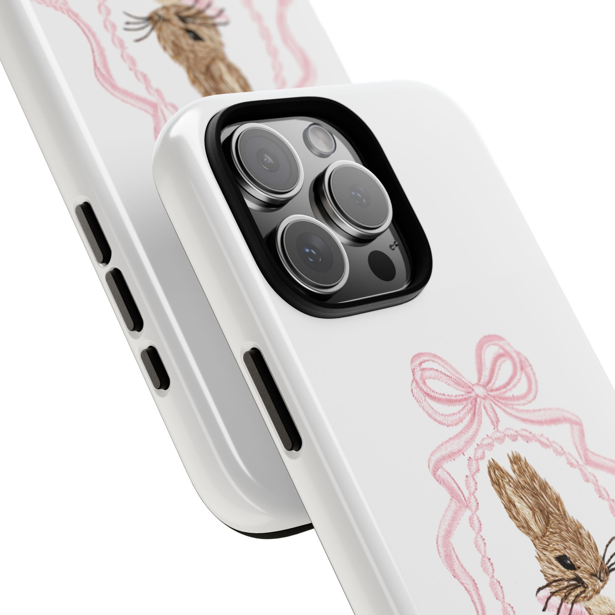 White phone case corner view with pink bow bunny print and camera lens cutouts