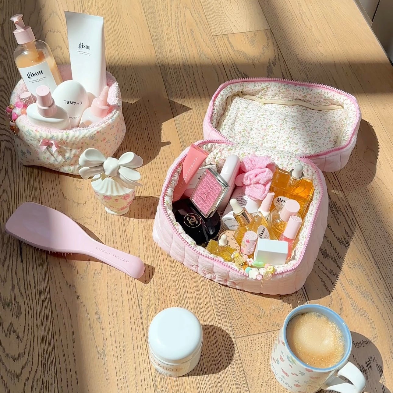 Pink quilted vanity bag opened flat, showing interior fabric and pink piping