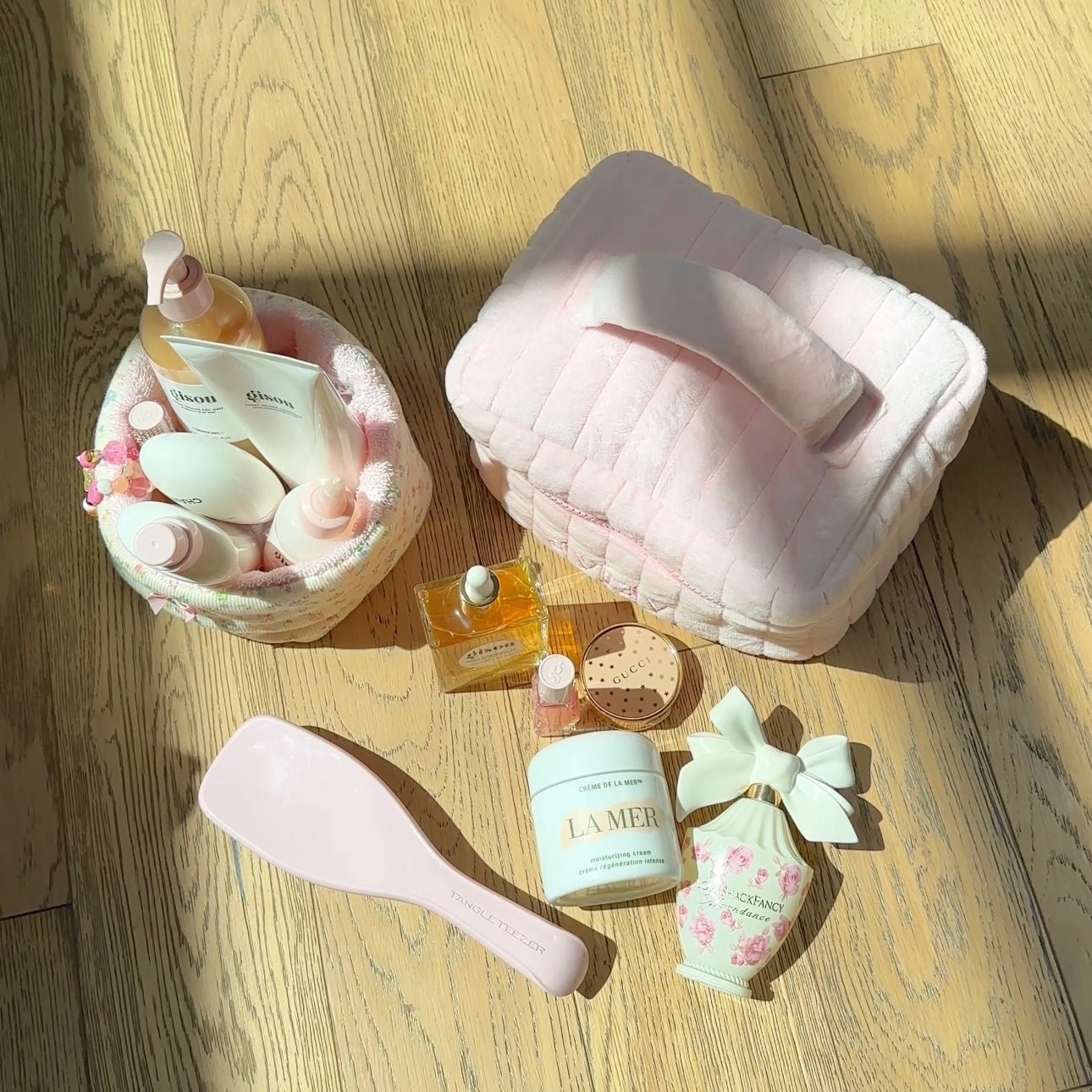 Pink quilted vanity bag with pink zipper, open top showing patterned interior lining