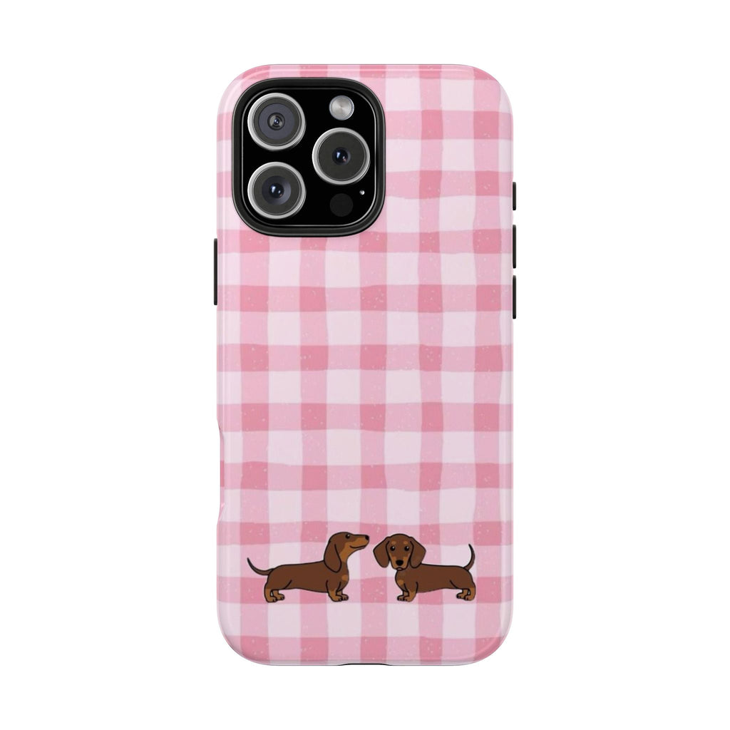 Pink gingham phone case with two dachshund puppy illustrations on the back