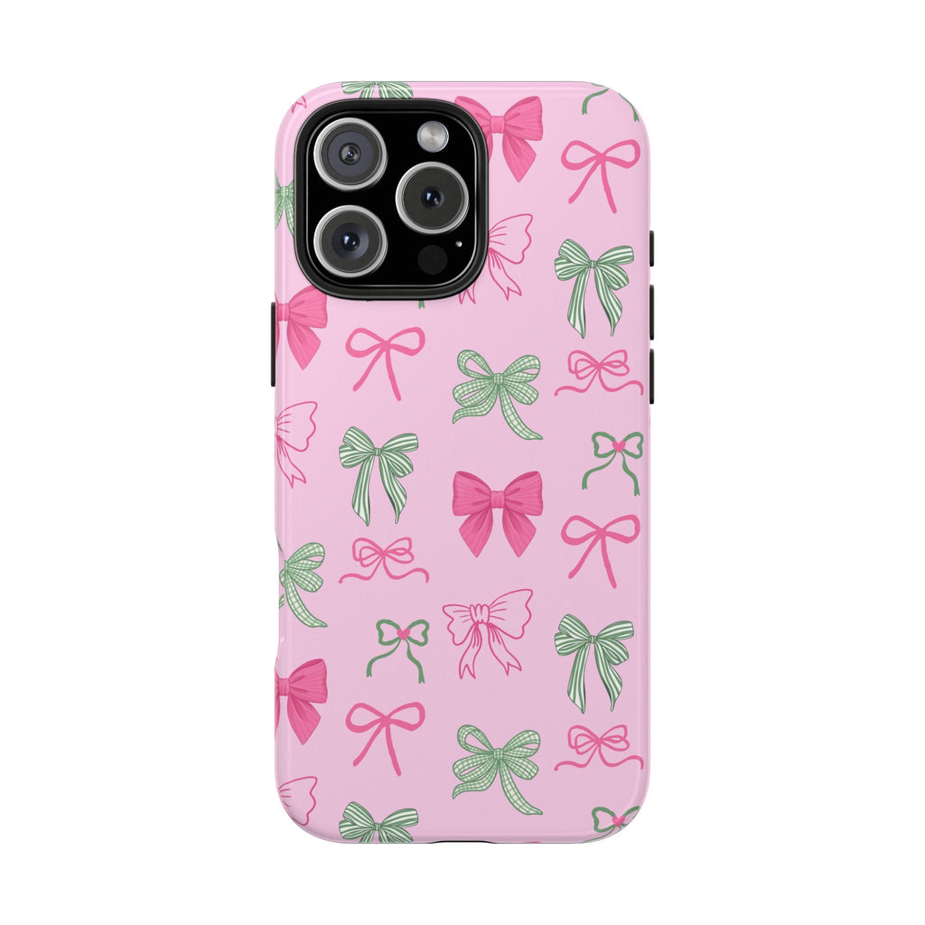 Pink phone case with green and pink bow pattern, raised camera cutout