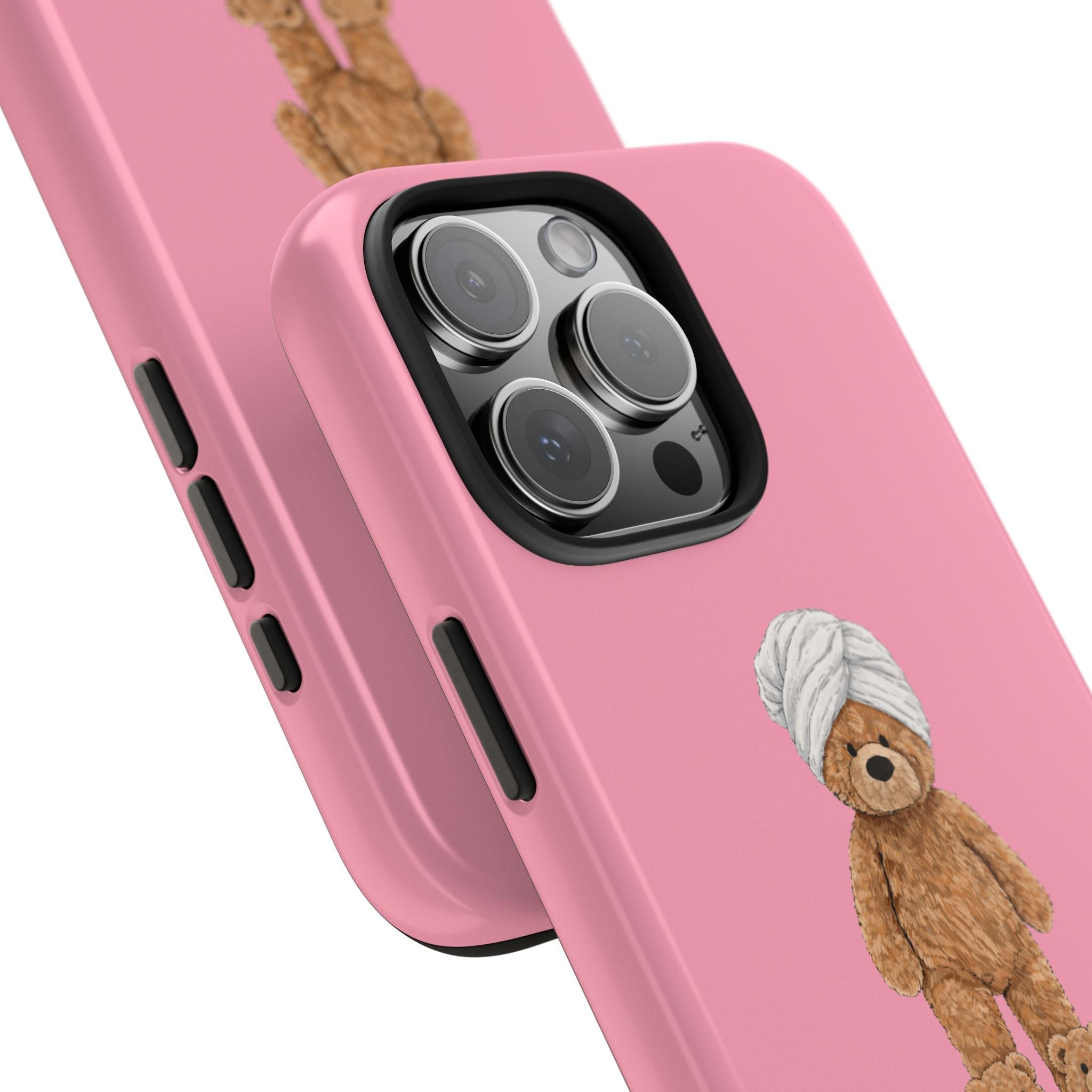 Pink phone case close-up: camera cutout and teddy bear character near bottom