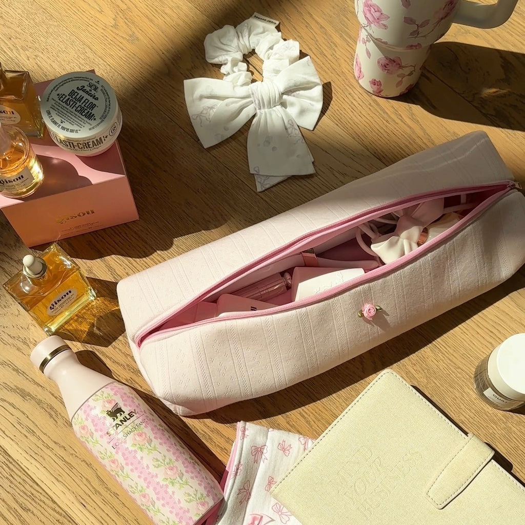 White lace-knit jacquard pouch opened, pink interior lining visible