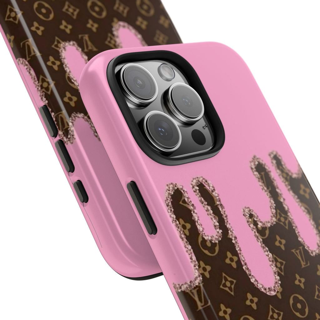 Side view of pink phone case with brown monogram drip print and camera lens openings