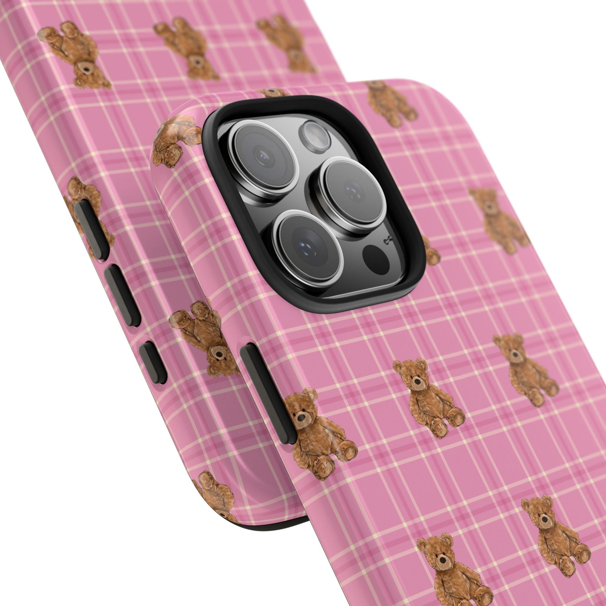 Angled view of pink plaid phone case with teddy bear pattern and camera lens cover