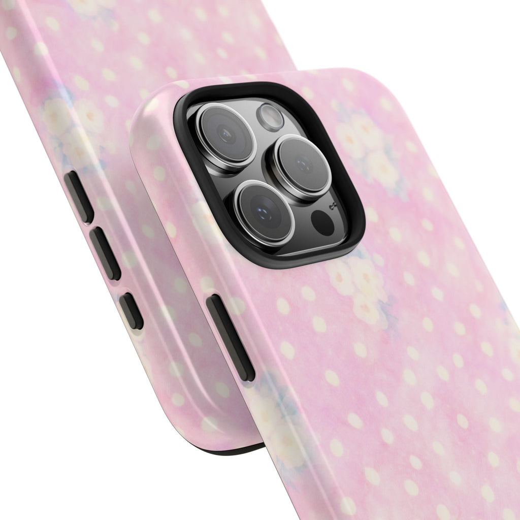 Angled view of pink polka dot floral phone case showing side buttons and camera bump