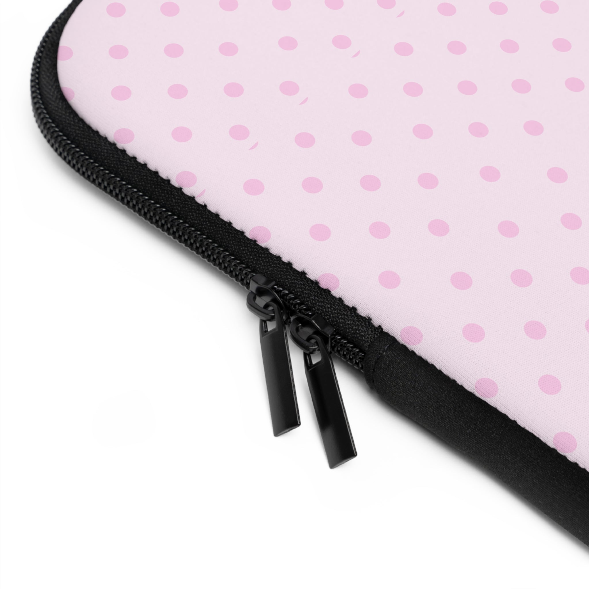 Close-up of pink polka dot neoprene sleeve edge with black zipper pull