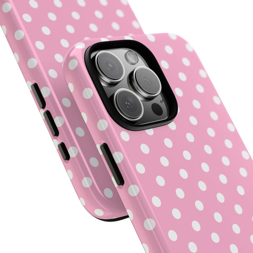 Pink phone case with white polka dots, angled view showing camera openings