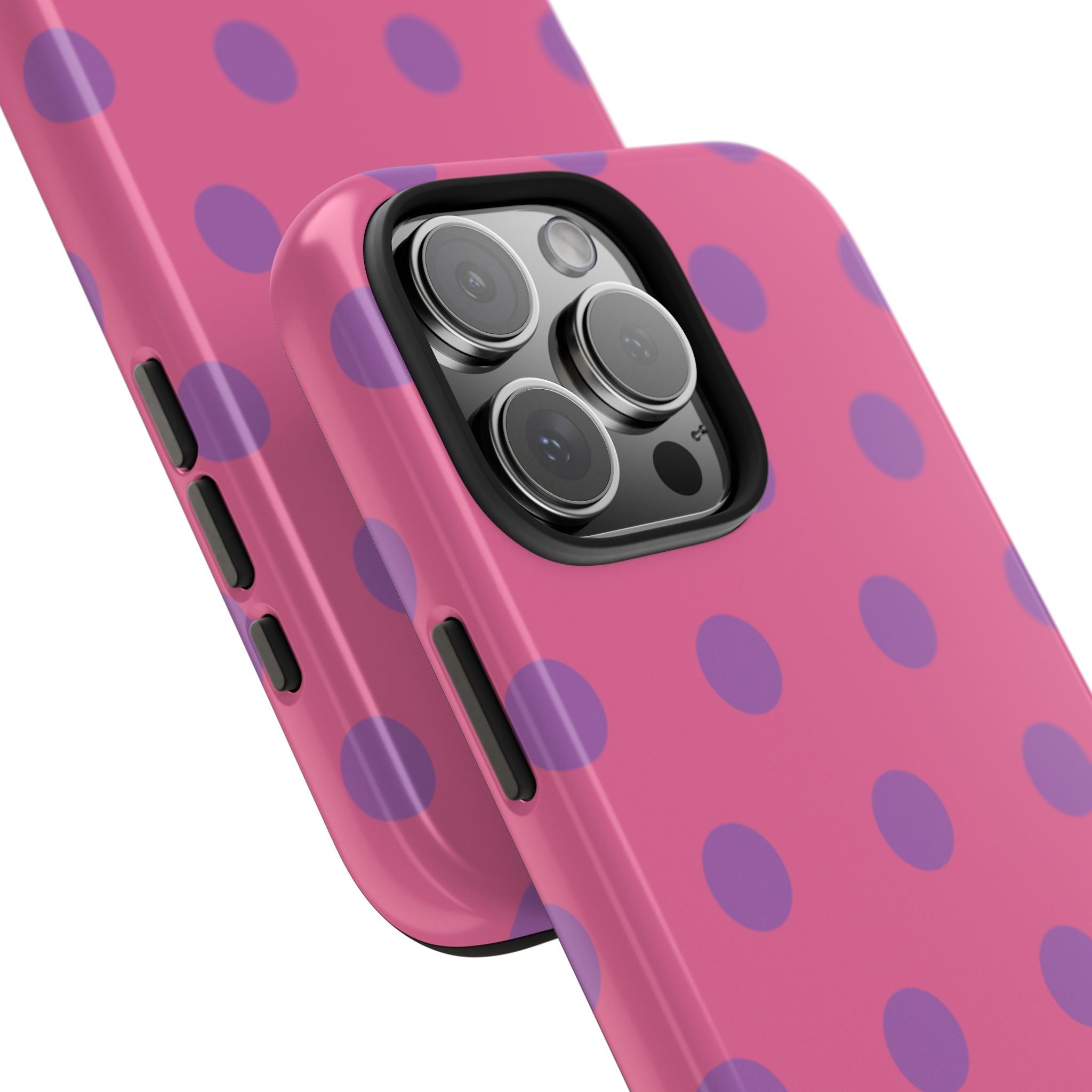 Close-up pink phone case with purple polka dots and triple lens camera opening