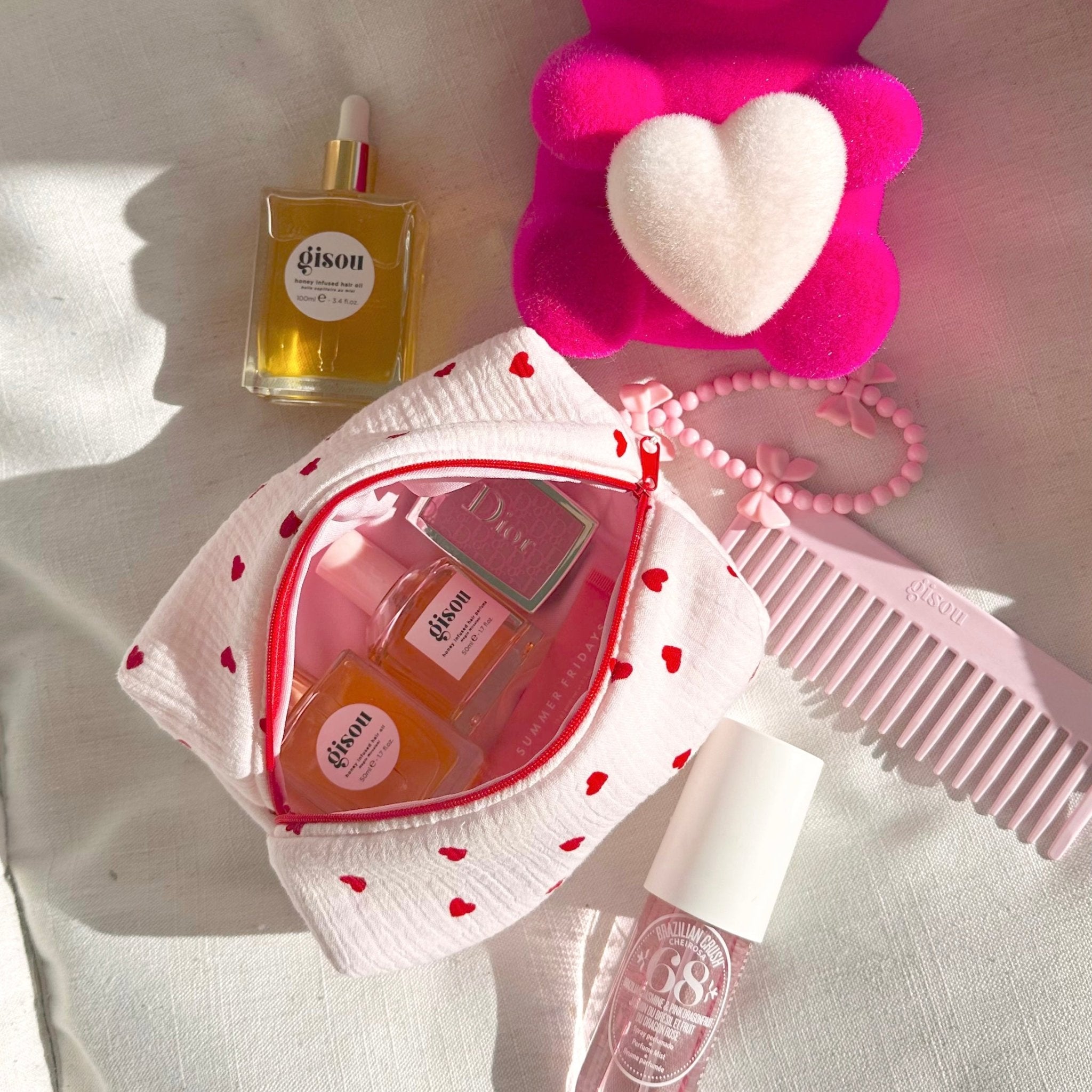 Heart-print zip pouch with red piping, open top showing pink lining