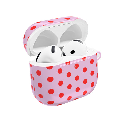 Pink AirPod case with red polka dots, lid open and white earbuds inside