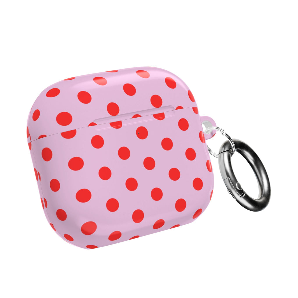 Pink AirPod case with red polka dots, closed lid with metal key ring