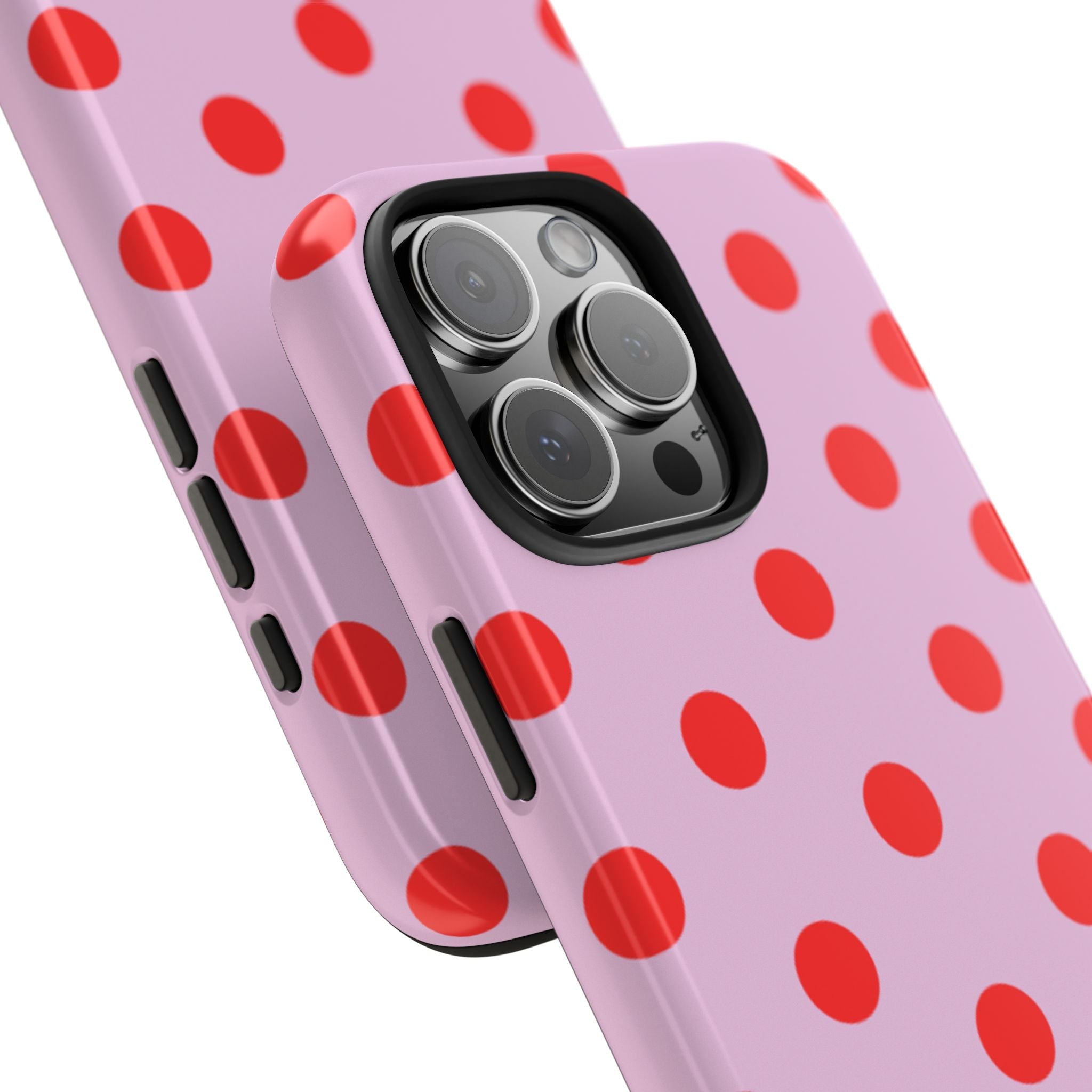 Detail view of pink phone case with red polka dots and camera lens cutout