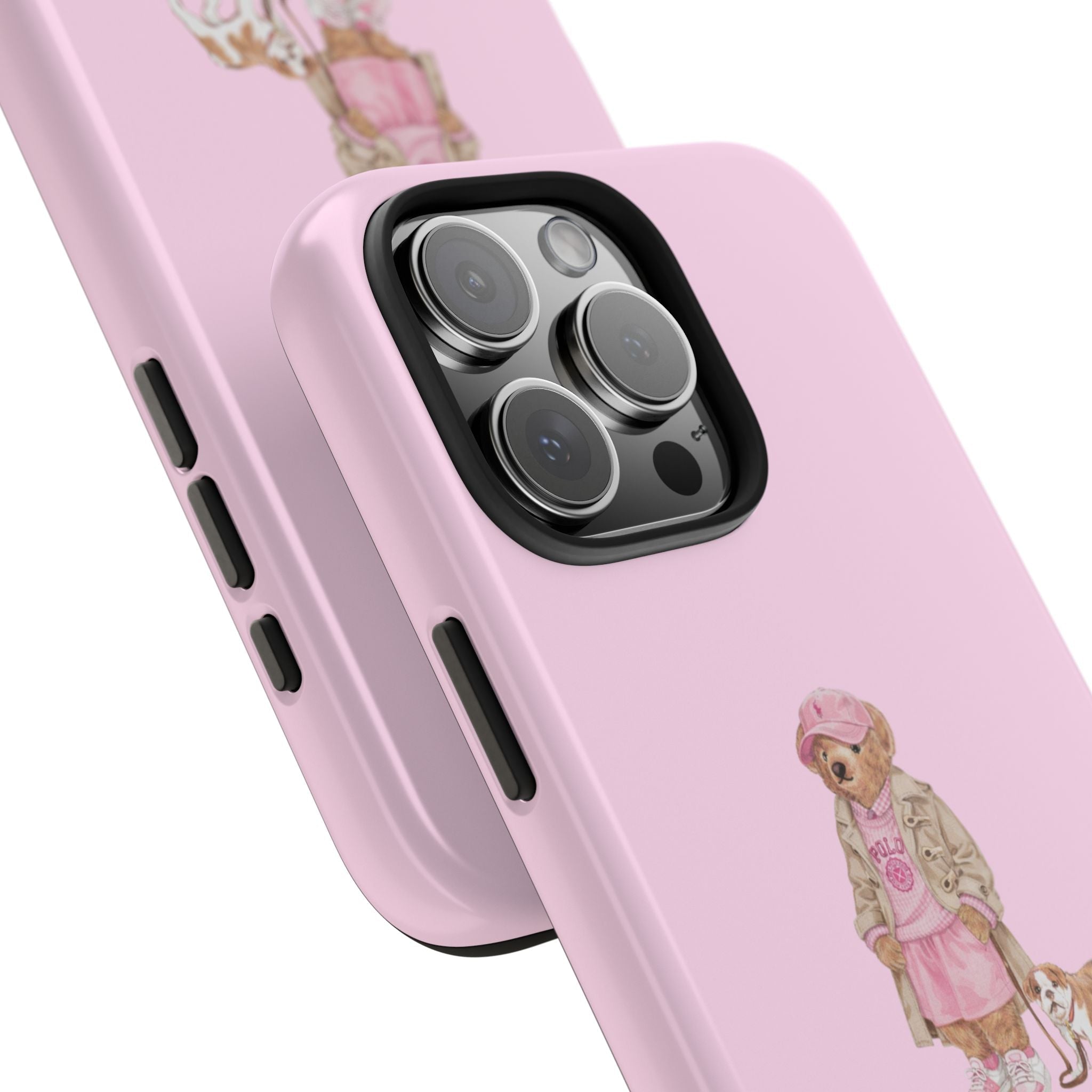 Pink phone case corner close-up showing teddy bear girl print and camera lens cutouts