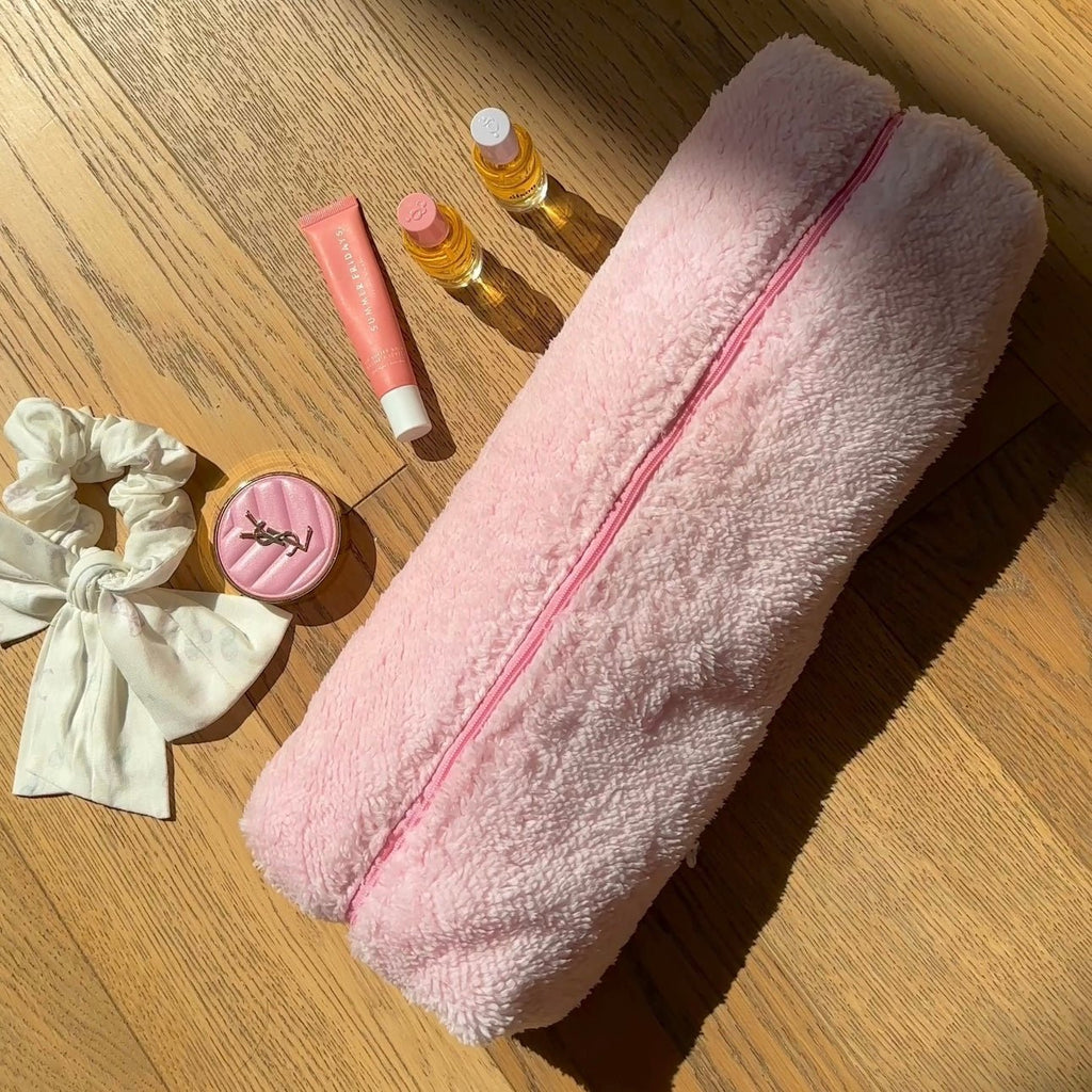 Light pink soft teddy zip pouch, long shape with pink zipper running down the center