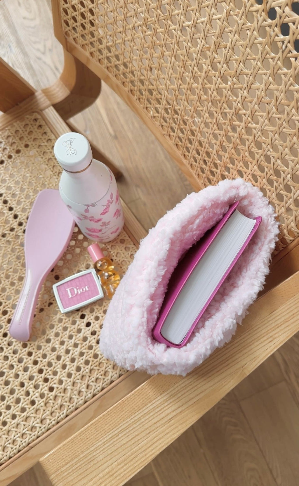 Pink teddy booksleeve open, showing padded interior and book slot