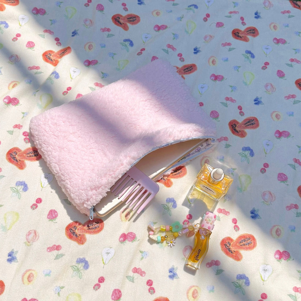 Pink teddy pouch with light-blue trim and floral-lined zipper opening