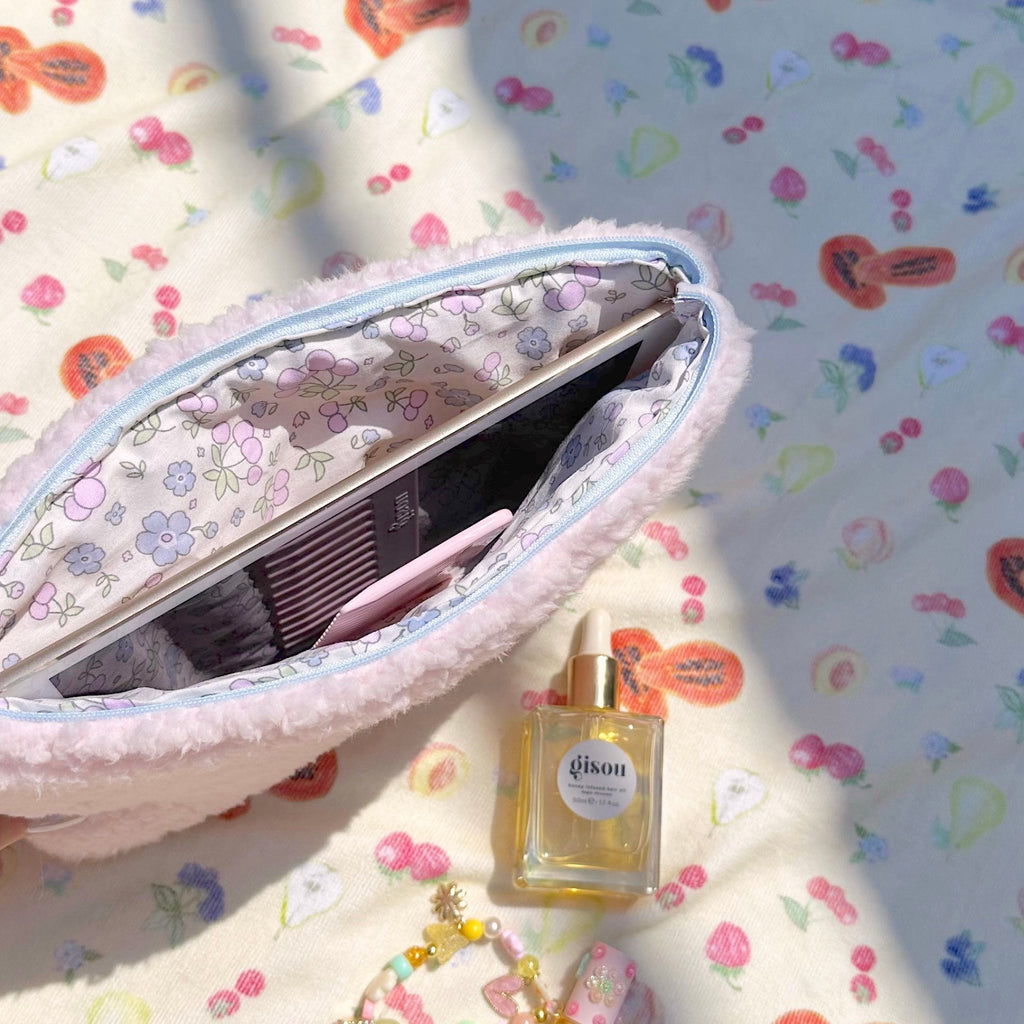 Open pink teddy pouch showing floral-pattern inner pocket