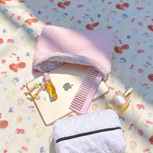 Pink teddy pouch with blue floral interior, zipper opening