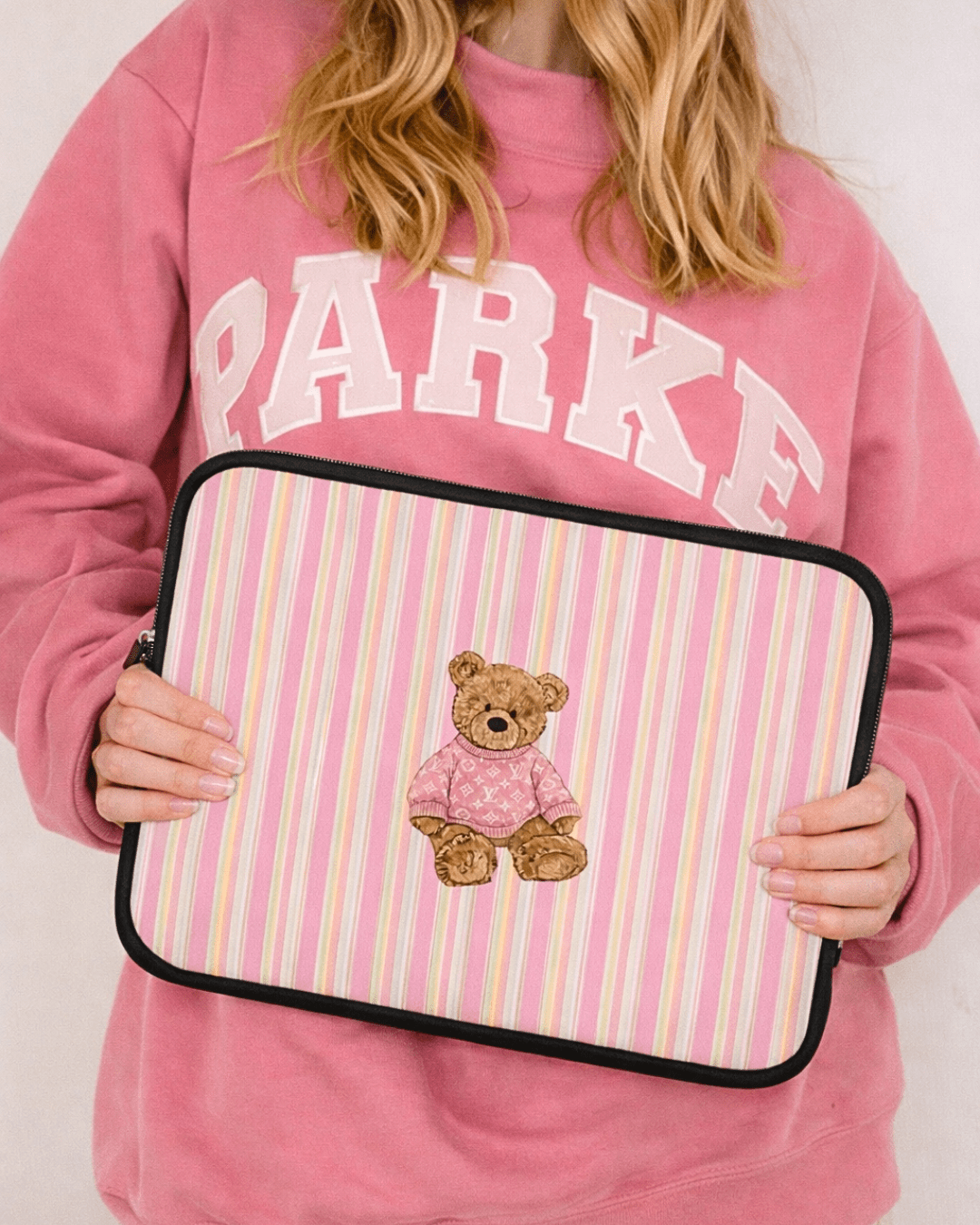 Pink striped neoprene device sleeve with teddy bear patch and black zipper trim