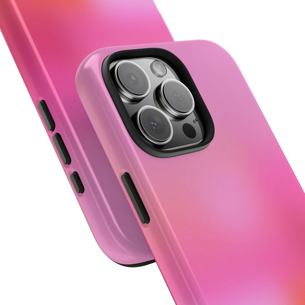 Angled close-up of pink sunrise aura phone case showing camera cutout and raised lens cover