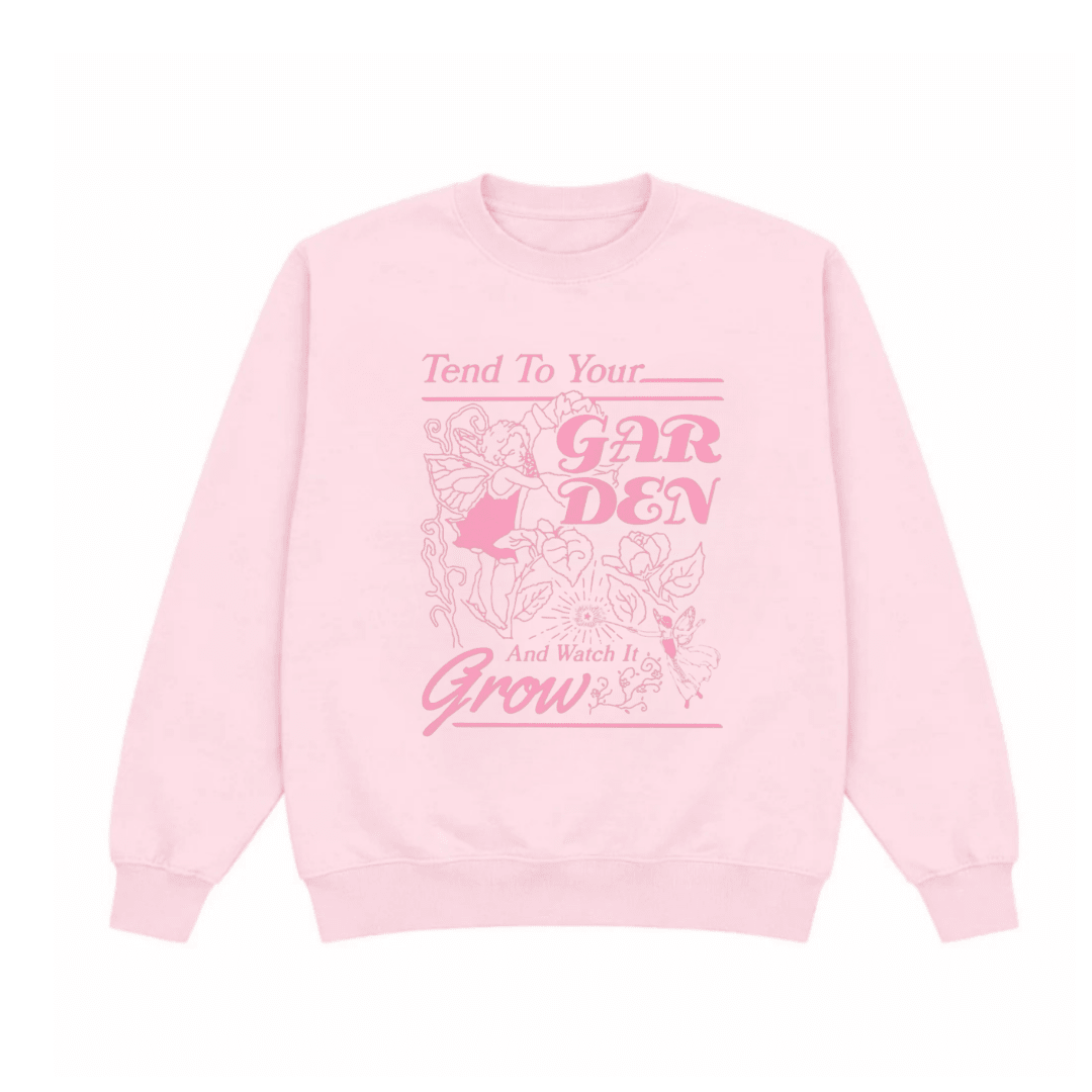 Pink crewneck sweatshirt with garden quote graphic on front