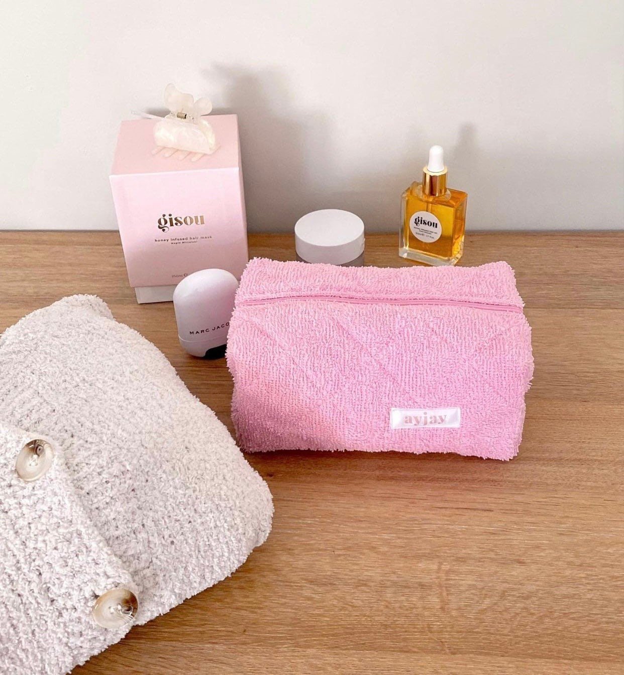 Pink terrycloth gingham pouch, rectangular shape with brand patch