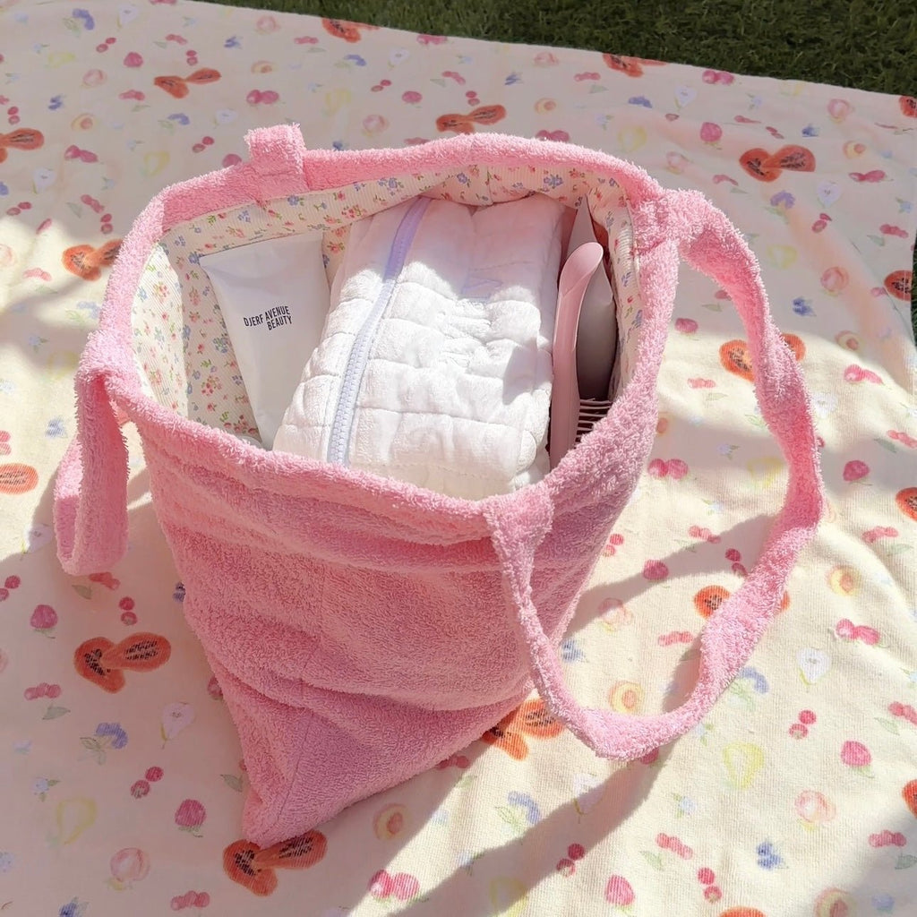 Pink terrycloth tote bag shown open, with lined interior and textured side panels.