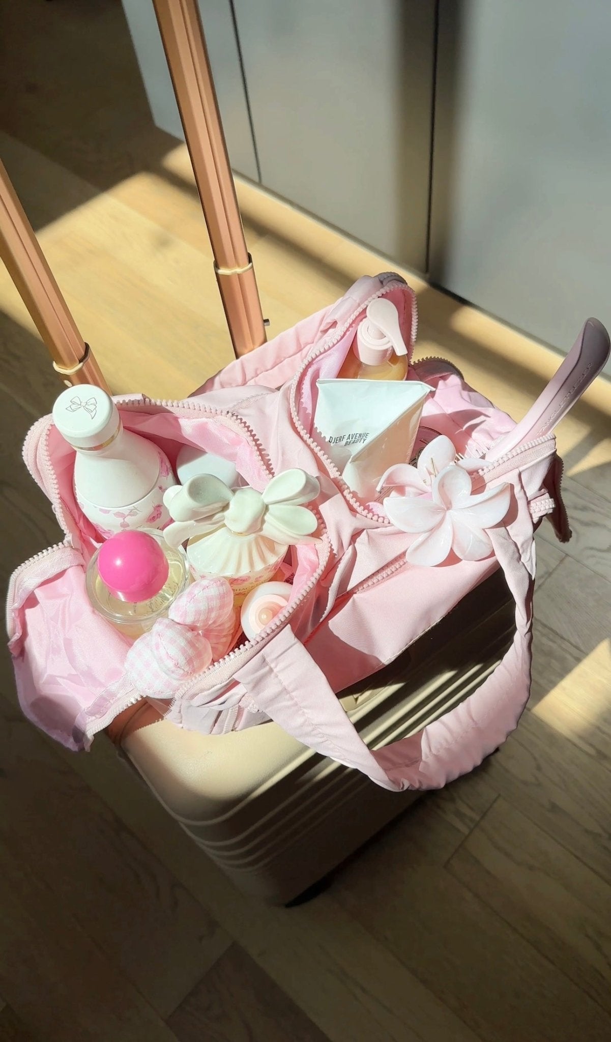 Pink waterproof organizer bag packed with baby bottles, wipes, and accessories
