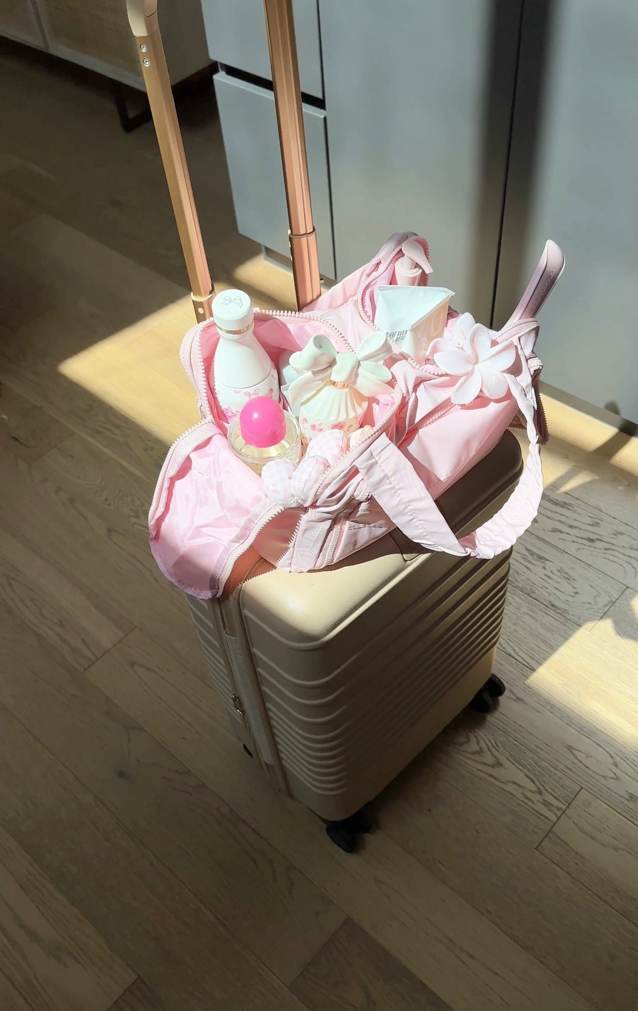 Pink waterproof organizer bag on a stroller with bottles and flower clips inside