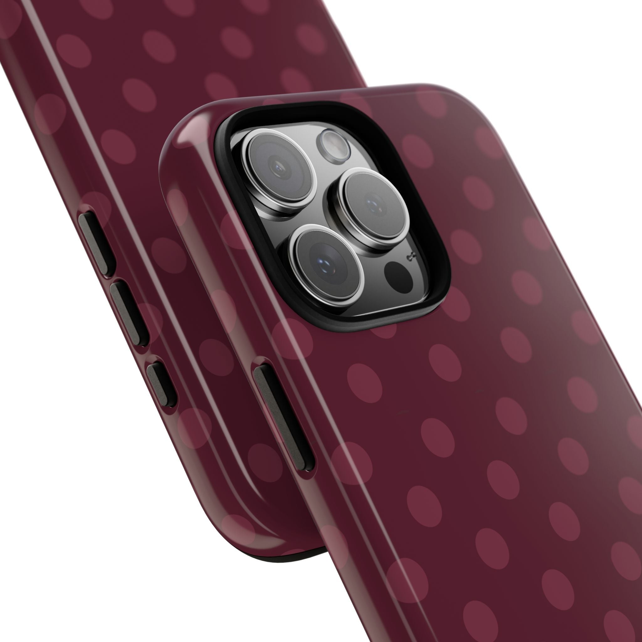 Plum phone case with polka dots, shows side buttons and camera lens openings