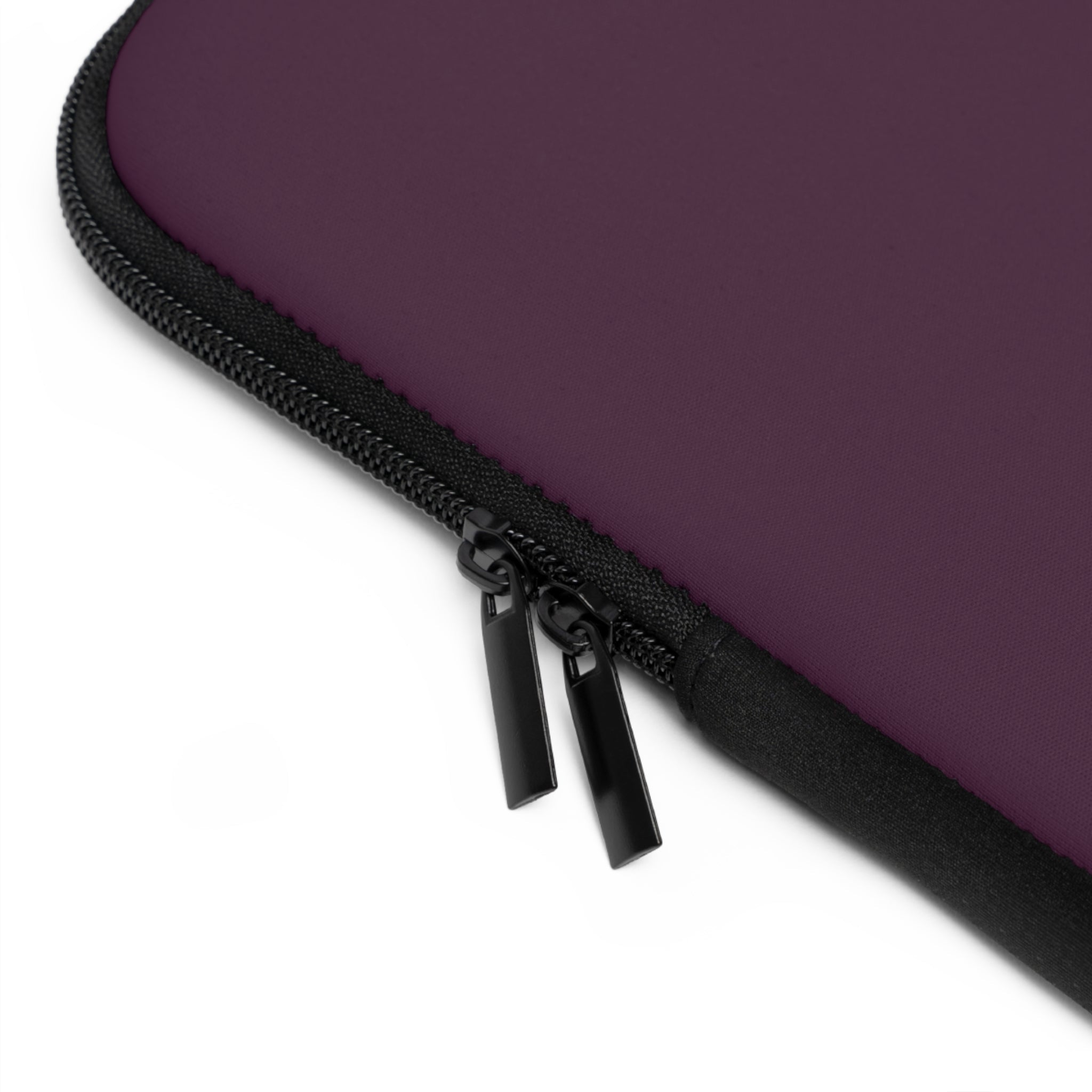 Close-up of black zipper on plum neoprene sleeve with stitched edge
