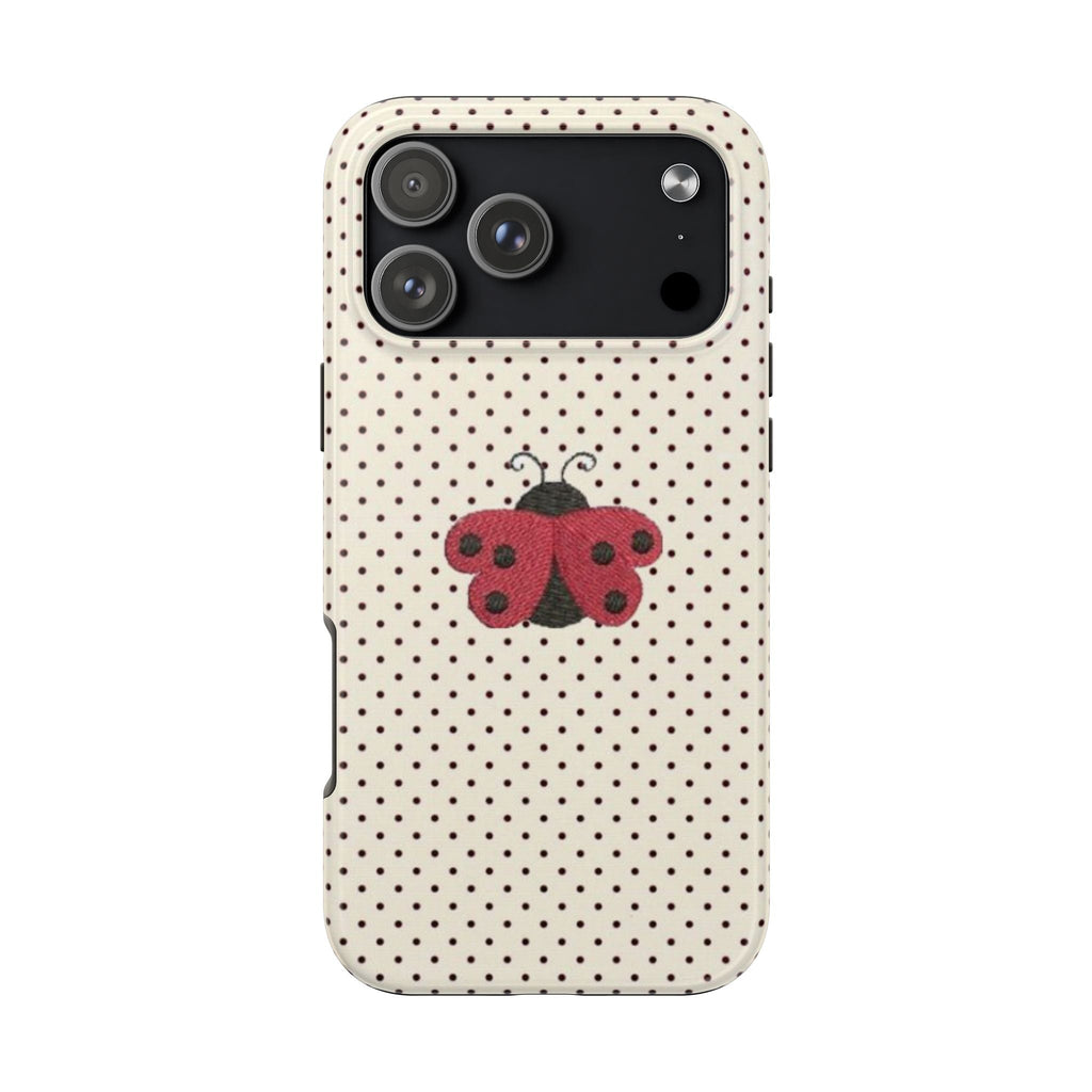 Cream polka-dot phone case with red ladybug coquette graphic and dual-lens camera cutout