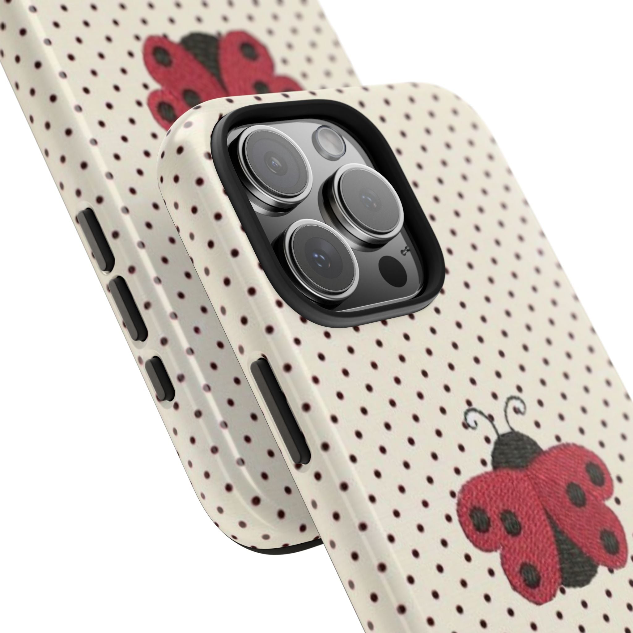Side view of cream polka-dot phone case with red ladybug design and raised camera bump