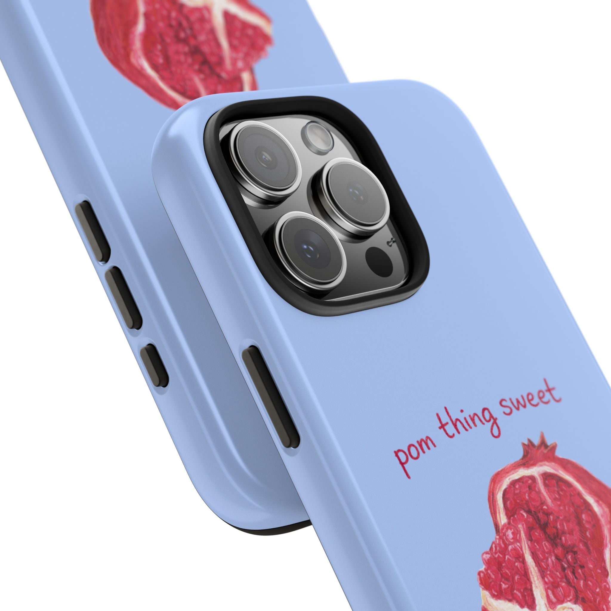 Light blue phone case in angle view with pomegranate design near camera cutouts