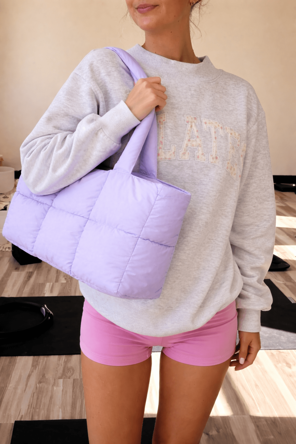 Purple quilted puffer duffle tote bag, wide shoulder straps